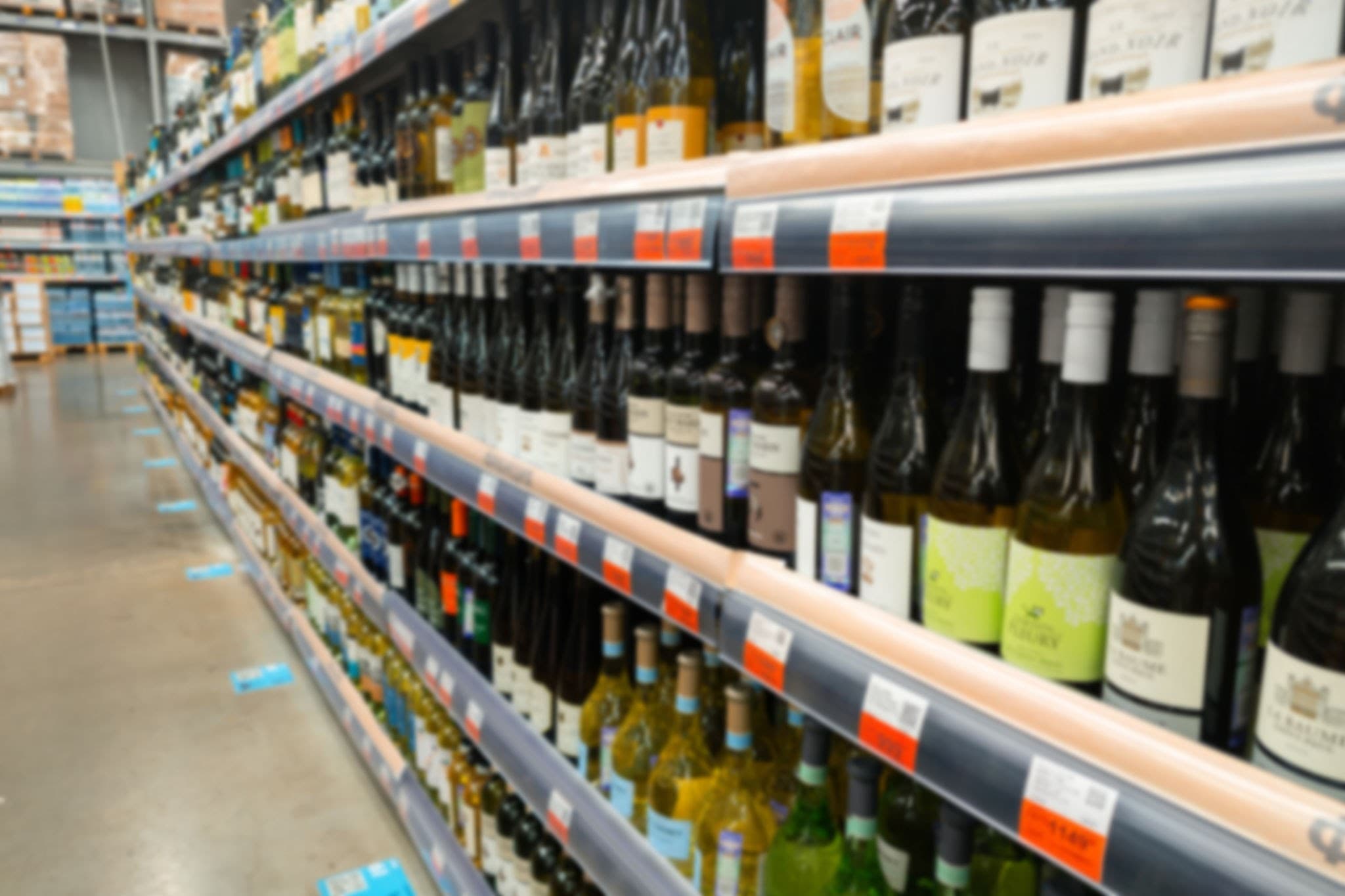 Supermarket aisle lined with wine bottles